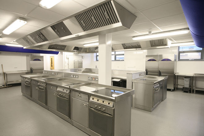 Island cooking range and ventilation canopy in corporate office